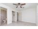 Bedroom featuring tile floors, a ceiling fan, closet, and connecting bathroom at 323 Scotland Dr, Daytona Beach, FL 32117
