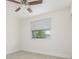 Bright bedroom featuring tiled floors, a ceiling fan, and a window at 323 Scotland Dr, Daytona Beach, FL 32117