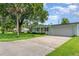 A house with a well-kept lawn and driveway leading to a two-car garage at 323 Scotland Dr, Daytona Beach, FL 32117
