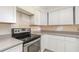 Updated kitchen featuring stainless steel oven, white cabinets, and stone countertops at 323 Scotland Dr, Daytona Beach, FL 32117