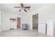 Open-concept living room with tile flooring and modern ceiling fan. Appliances are ready for installation at 323 Scotland Dr, Daytona Beach, FL 32117