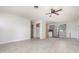 A living room showing an open layout with tile floors and a view into the kitchen area at 323 Scotland Dr, Daytona Beach, FL 32117