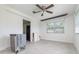 Spacious living room featuring neutral paint, updated fixtures and a ceiling fan and tile flooring at 323 Scotland Dr, Daytona Beach, FL 32117