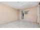 Enclosed porch with tiled floors, neutral paint and a door that leads to the exterior at 323 Scotland Dr, Daytona Beach, FL 32117