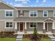 Charming townhome featuring a welcoming porch and well-maintained landscaping at 3279 Gardenia Reserve St, Apopka, FL 32712