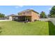 Spacious backyard with a screened-in patio, green lawn, privacy fence, and space for outdoor activities at 352 Giovani Blvd, Clermont, FL 34715