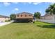 Spacious backyard featuring a screened-in patio and a well-maintained lawn, perfect for outdoor activities at 352 Giovani Blvd, Clermont, FL 34715