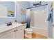 Charming bathroom with a white vanity, shower-tub combination, and nautical-themed decor at 352 Giovani Blvd, Clermont, FL 34715