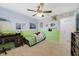 Cheerful bedroom with a ceiling fan, desk, and playful decor at 352 Giovani Blvd, Clermont, FL 34715