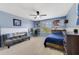 Bedroom with blue accent wall, white trim, ceiling fan, and natural light from the window at 352 Giovani Blvd, Clermont, FL 34715