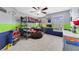 Fun bedroom featuring a bunk bed, beanbag chair, and colorful walls with racing decor at 352 Giovani Blvd, Clermont, FL 34715
