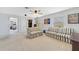 Upstairs bonus room featuring two striped sofas, carpet, and lots of natural light at 352 Giovani Blvd, Clermont, FL 34715