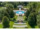 Aerial view of community pool surrounded by manicured gardens and lush landscaping, offering a resort-style experience at 352 Giovani Blvd, Clermont, FL 34715