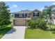 Beautiful two-story home with lush landscaping, attached two-car garage, and inviting curb appeal at 352 Giovani Blvd, Clermont, FL 34715