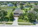 Well-maintained two-story home with a manicured lawn, fenced yard, and mature trees in a suburban neighborhood at 352 Giovani Blvd, Clermont, FL 34715