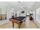 Game room features a pool table, tile flooring, and views to the dining room at 352 Giovani Blvd, Clermont, FL 34715