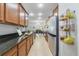 Long galley kitchen featuring granite countertops, stainless steel appliances, and tiled floors for a modern look at 352 Giovani Blvd, Clermont, FL 34715