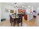 Open kitchen and dining area featuring sleek countertops, stainless steel appliances, and a cozy dining table at 352 Giovani Blvd, Clermont, FL 34715