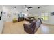 Inviting living room with tile flooring, large windows, and comfortable seating arrangements at 352 Giovani Blvd, Clermont, FL 34715