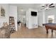 Open living area with tile flooring, a ceiling fan, and a TV, creating a welcoming and comfortable space at 352 Giovani Blvd, Clermont, FL 34715