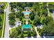 Aerial view of a community pool, landscaped with manicured shrubs, trees, and a covered recreation area at 352 Giovani Blvd, Clermont, FL 34715
