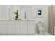 Bright bathroom featuring a white vanity with double sinks, a toilet, and stylish decor at 367 Sol Vista Dr, Dundee, FL 33838