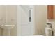 Minimalist bathroom with a pedestal sink, modern fixtures, and fresh, neutral tones at 367 Sol Vista Dr, Dundee, FL 33838