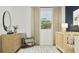 Well-lit Bedroom with wooden crib, rocking chair, modern dresser, and neutral decor for a calming space at 367 Sol Vista Dr, Dundee, FL 33838