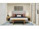 Bedroom featuring a bed with a gray upholstered headboard, bench, and stylish decor with a modern feel at 367 Sol Vista Dr, Dundee, FL 33838
