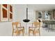 Open-concept dining area with modern art, a round table, and seating for four at 367 Sol Vista Dr, Dundee, FL 33838