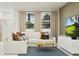 Bright living area featuring modern furniture and large windows with backyard views at 367 Sol Vista Dr, Dundee, FL 33838
