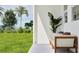 Relaxing patio scene with white chairs, outdoor view of lawn, palm trees, and greenery at 367 Sol Vista Dr, Dundee, FL 33838