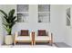 Serene patio with white armchairs, brown cushions, potted plant, and windows for bright indoor-outdoor living at 367 Sol Vista Dr, Dundee, FL 33838