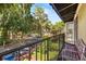 Balcony view overlooking a street with mature trees and a parking area at 3946 Versailles Dr # 3946B, Orlando, FL 32808