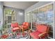 Enclosed balcony featuring an outdoor seating area and sliding glass door to interior at 3946 Versailles Dr # 3946B, Orlando, FL 32808