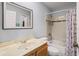 Bathroom with a shower-tub combination, a single sink vanity, and white tiling at 3946 Versailles Dr # 3946B, Orlando, FL 32808