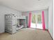 Cozy bedroom featuring a bunk bed and access to a private balcony with pink curtains at 3946 Versailles Dr # 3946B, Orlando, FL 32808