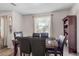 Elegant dining room featuring hardwood floors, a marble table, and dark wood chairs with an area rug at 3946 Versailles Dr # 3946B, Orlando, FL 32808