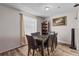 Charming dining room featuring wood-look flooring, a decorative area rug, and a dark wood table set for six at 3946 Versailles Dr # 3946B, Orlando, FL 32808