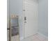 An entryway features a modern mirror and a secure white door at 3946 Versailles Dr # 3946B, Orlando, FL 32808