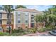 A condominium complex with a stucco exterior and well-maintained landscaping at 3946 Versailles Dr # 3946B, Orlando, FL 32808