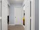Hallway with multiple doors leading to bathroom and storage spaces, plus light-colored carpet flooring at 3946 Versailles Dr # 3946B, Orlando, FL 32808