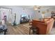 Comfortable living room featuring a TV, wood flooring, and orange couch with decorative vases at 3946 Versailles Dr # 3946B, Orlando, FL 32808