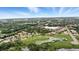 Expansive aerial view of the community with mature trees, green spaces and serene lake at 3995 Equine Cv, Lake Mary, FL 32746