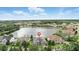 Aerial view shows a home with lush landscaping near a lake at 3995 Equine Cv, Lake Mary, FL 32746