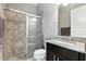 Well-appointed bathroom features a glass-enclosed shower and granite countertop vanity at 3995 Equine Cv, Lake Mary, FL 32746