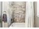 Close-up of a tiled shower and bathtub combination with a shower curtain and towel rack for a modern bathroom aesthetic at 3995 Equine Cv, Lake Mary, FL 32746
