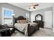 Comfortable bedroom features a dark wood bed frame and dresser, plush armchair, and ample lighting at 3995 Equine Cv, Lake Mary, FL 32746