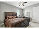 Bedroom with a wooden sleigh bed, decorative pillows, and dark furniture, creating a warm and inviting atmosphere at 3995 Equine Cv, Lake Mary, FL 32746