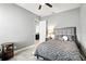 Bedroom with neutral tones, tile floors, and a gray upholstered headboard at 3995 Equine Cv, Lake Mary, FL 32746